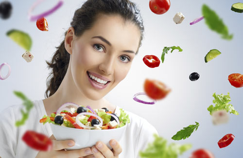 Kvinde der holder skål med sund salat